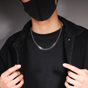 Classic 12mm silver stainless steel Cuban link chain necklace worn by a male model