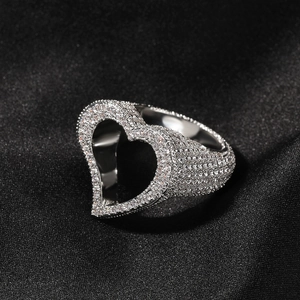 Détail de la bague coeur en argent sertie de zircons sur un fond en soie noire