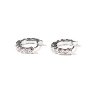 Detailed view of silver hoop earrings featuring pavé set cubic zirconia on the outer band