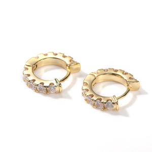 Polished gold huggie hoop earrings featuring sparkling round-cut cubic zirconia inlays