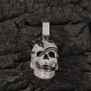 Detailed view of silver skull pendant with black snakes and inlaid zircon stones