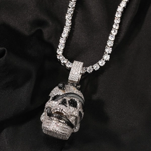 Macro shot of a hip hop skull and snake pendant necklace set with cubic zirconia stones