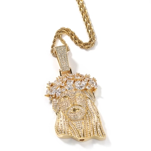 Close-up of gold Jesus pendant with iced-out cubic zirconia stones on rope chain