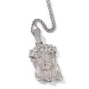 Macro shot of silver hip hop Jesus pendant with iced-out cubic zirconia stones