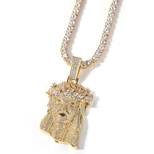 Close-up detail of iced out gold Jesus piece pendant with tennis chain and zircon stones