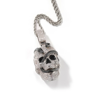 Macro shot of micro-pave skull pendant with snake detail and classic rope chain