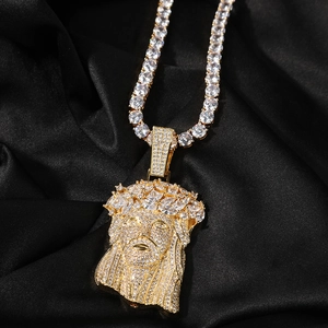 Macro shot of hip hop Jesus pendant with shimmering cubic zirconia on black silk