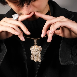 Hip hop Jesus pendant with clear zircons and square iced out ring on a person