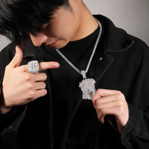 Detailed view of hip hop iced out Jesus pendant, tennis chain and square ring set