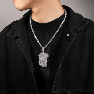 Close-up of hip hop Jesus pendant with cubic zirconia on a silver tennis chain for men