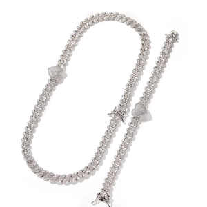 Detailed macro of silver Cuban chain set with iced out heart charms and pave zircon stones
