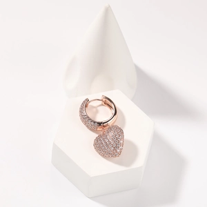 Hip hop rose gold heart earring with full zircon stones on a white geometric stand
