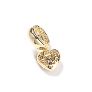 Macro detail of gold plated heart earrings featuring cubic zirconia and hollow back design