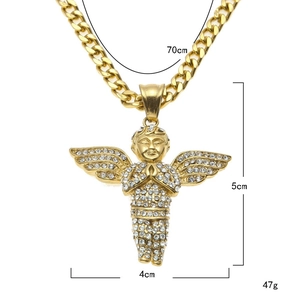 Macro shot showing 18k gold plated angel wing pendant with white zircon on Cuban chain