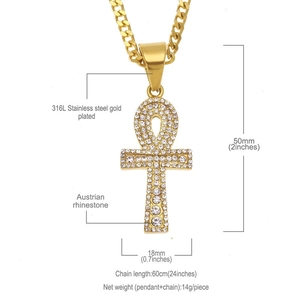 Macro detail of gold plated 316L stainless steel Ankh cross pendant with shiny rhinestones