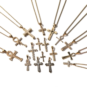 Collection of gold-plated cross and Ankh pendant necklaces on white background