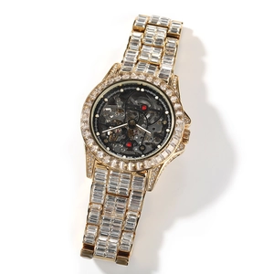Macro shot of fully iced-out gold skeleton watch with exposed gears and Swiss movement