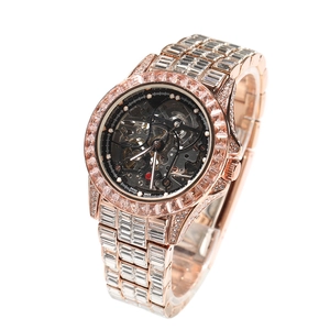 Macro detail of rose gold automatic skeleton watch with baguette-cut zircons and Swiss Made mark