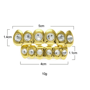 Macro shot of gold-plated hip hop teeth grills with dimensions and weight specs
