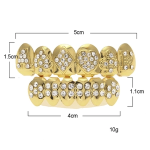 Detailed view of gold plated iced out hip hop teeth grills with dimension measurements