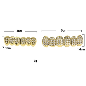 Detail view of hip hop gold teeth grills with sizes 5cm and 4cm showing white rhinestones