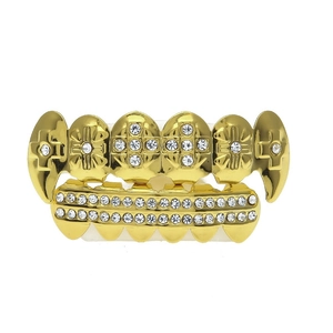 Detailed macro view of gold-plated hip hop teeth grillz with cross design and white rhinestones