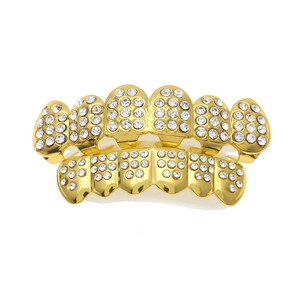Detailed macro view of hip hop gold teeth grills with sparkling micro-pave crystals