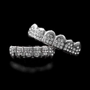 Macro detail of silver hip hop teeth grillz set with sparkling iced out pave diamonds