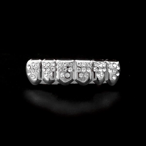 Macro detail of silver plated six-tooth hip hop grillz with shimmering cubic zirconia