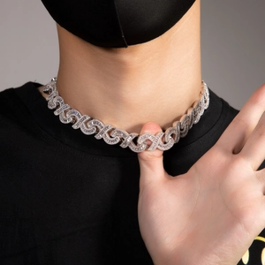 Close-up of hip hop silver necklace with iced out crystals on a male model with mask
