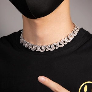 Close-up of hip hop cuban chain featuring iced out rhinestones worn by male model