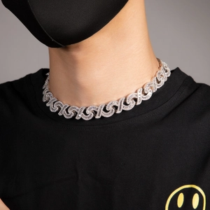 Macro detail of men hip-hop silver Cuban chain with 15mm iced-out infinity links