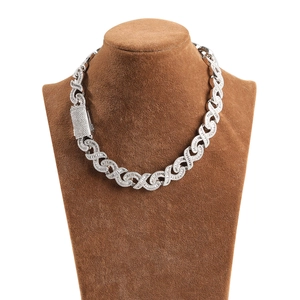 Close-up of hip hop silver necklace with X-shaped links and full diamond setting