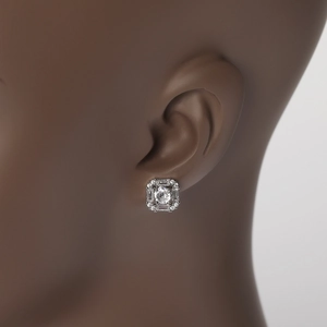 Macro close-up of square halo earring with baguette-cut diamonds on female ear