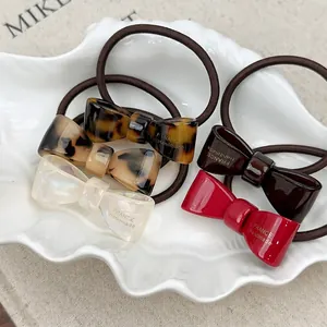 Set of 5 French acetate bow hair ties in assorted colors with gold handmade logo