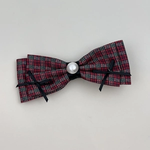 Classic red and green plaid bow hair clip with pearl center and black ribbon details