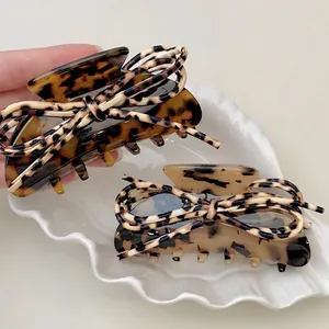Leopard print bow shark clip hair claw accessory made of polished PU leather and acetate