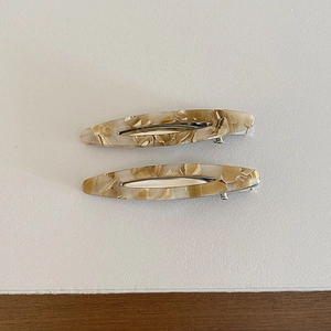Set of two minimalist acetate leaf hair clips with elegant cream amber marble patterns