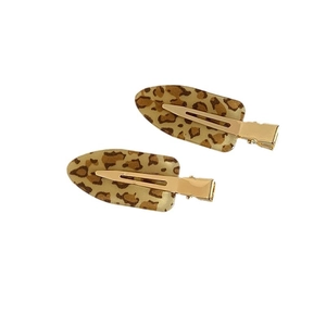 Pair of stylish leopard print hair clips with golden metal base for women's hair styling