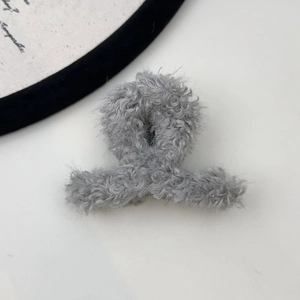 Detailed view of the soft grey faux shearling plush texture on this large hair claw clip