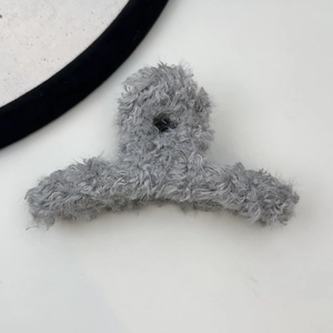 Detail view of the soft grey plush texture on the large claw clip for autumn and winter