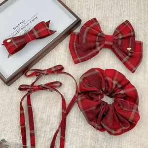 Classic red plaid hair bow set featuring hair clips, scrunchie and ribbons on waffle fabric