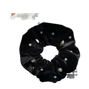 Elegant black velvet scrunchie with white pearl embellishments for hair styling