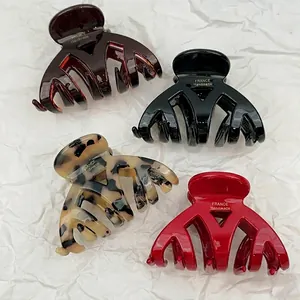Set of four glossy acetate hair claws in dark coffee, black, tortoiseshell, and red colors