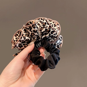 Detailed close-up of handmade leopard print scrunchie with high elastic hair tie