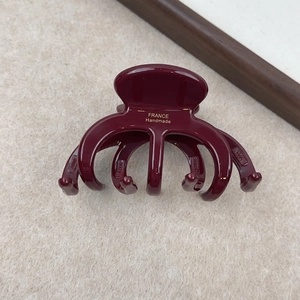 Détail de la pince à cheveux bordeaux avec inscription dorée France Handmade