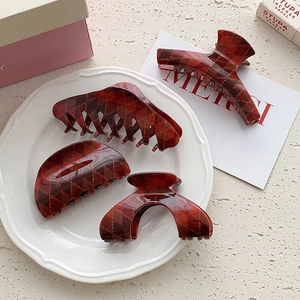 Set of four vintage red checkered hair claws with British style argyle pattern on tray