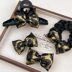 Chic leopard print hair accessories set including matte claw clip and satin scrunchie