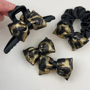Leopard print hair accessory set with black bow claw clip and satin scrunchie