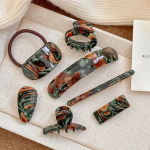 Elegant tortoiseshell acetate hair clip set with marble patterns and gold lettering